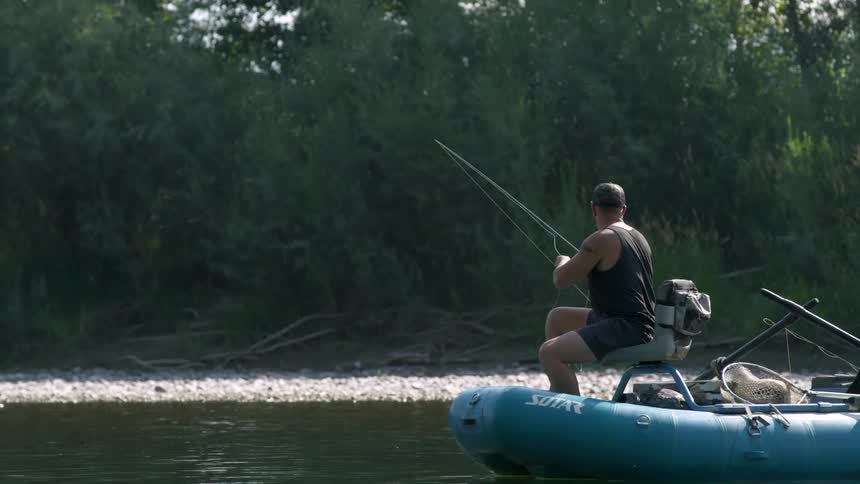 Man riding a fishing boat in a river
