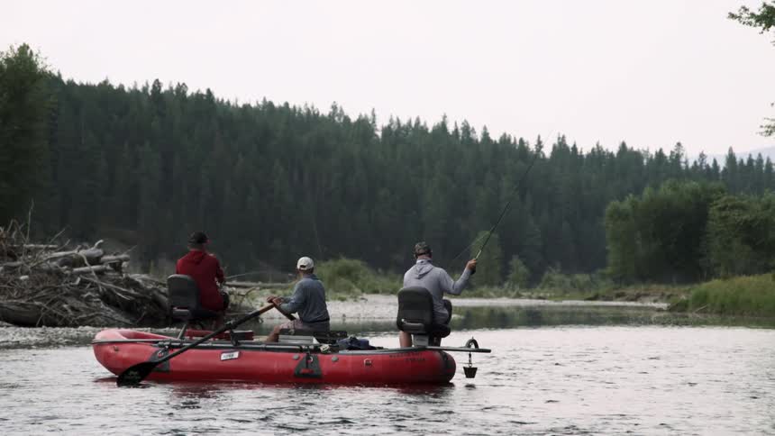 Three men are fishing on the raft