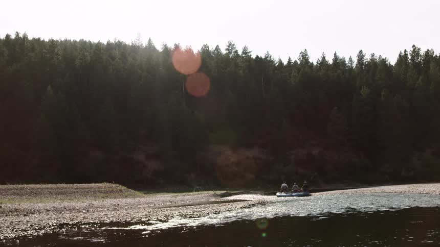 Three people in a boat on a lake