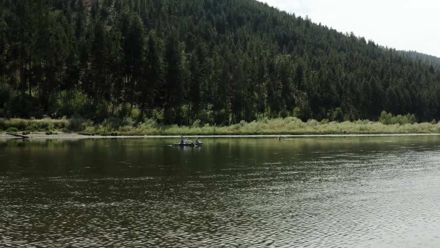 Two people make their way down a river in a kayak