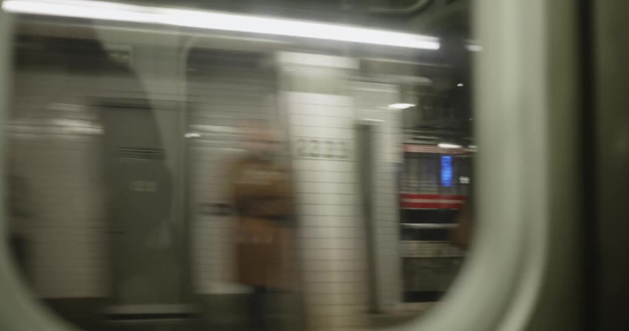 Two subway trains travel past each other