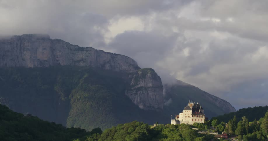 A very large house with high mountain landscape in the background