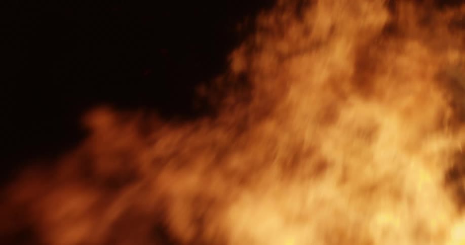 Flames from an outdoor fire grow bigger and taller