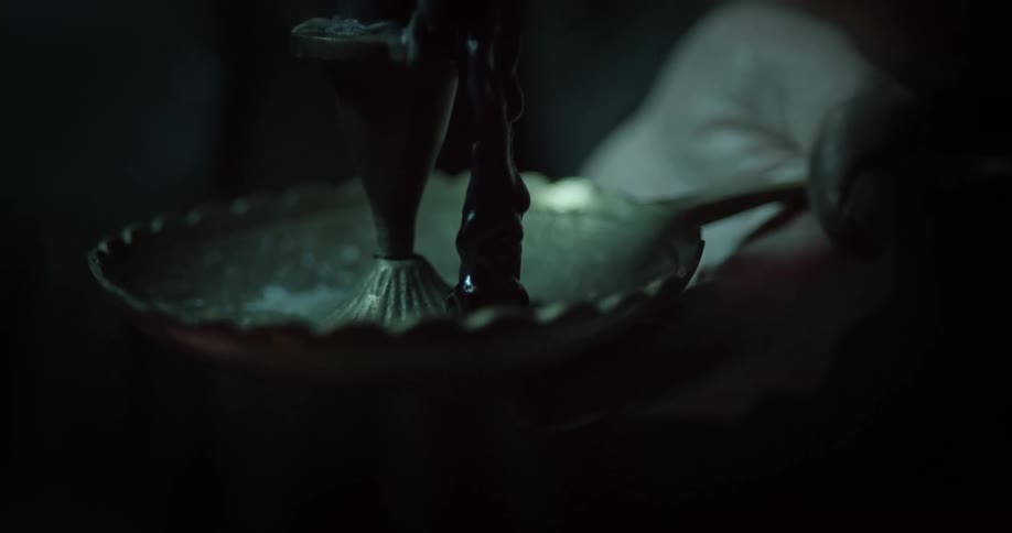 A person holding a melted candle
