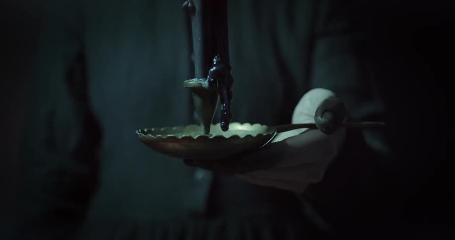 A person holding a candle in their hand