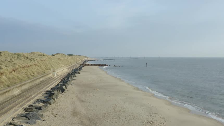 Landscape view of a road lined with rocks just off the coast