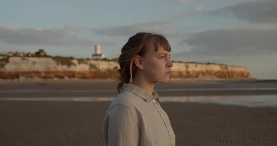 A teenager walks along the beach