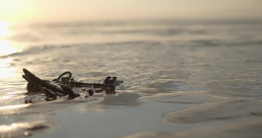 Water running over old keys lying on the beach