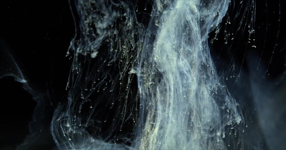 The smoke rises and swirls in the dark