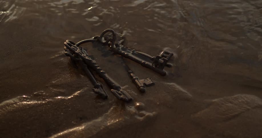 Water washing over a set of old keys in the sand