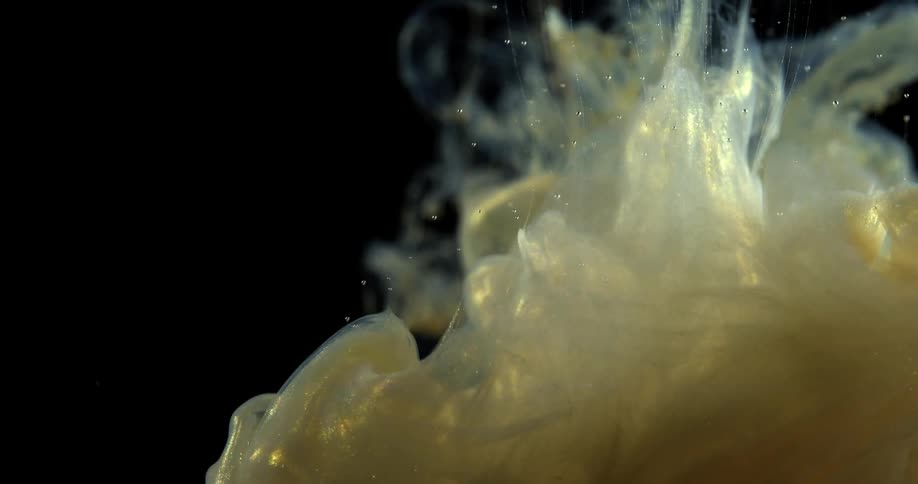 A thick liquid billows when poured into a clear solution