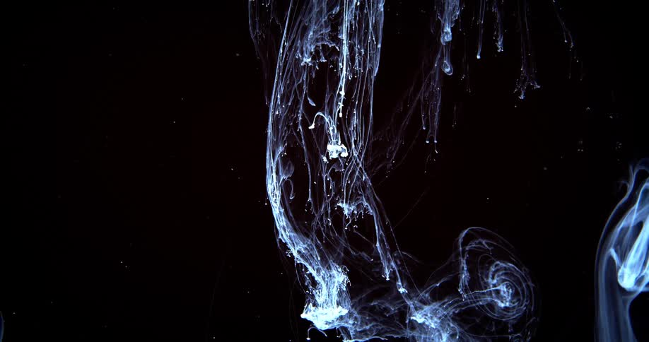 A white substance pours and spreads out in a solution