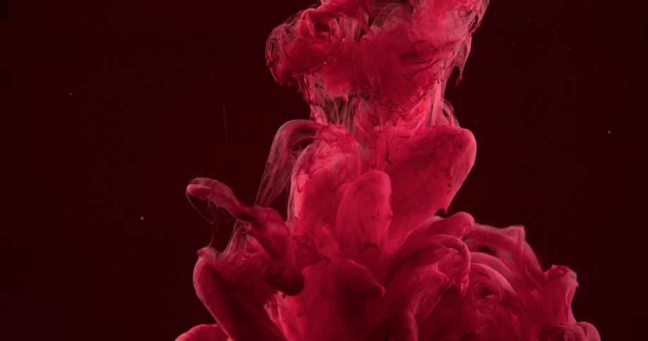 Red cloud of particles sinking in water