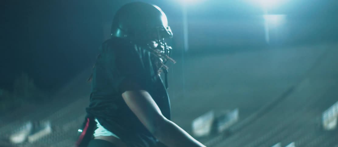 A football player throws the ball and cheers