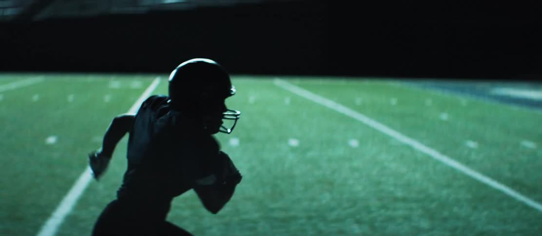 A player on a football team runs the ball in for a touchdown