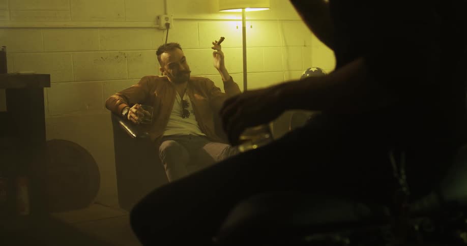 People sitting at home smoking drinking and talking