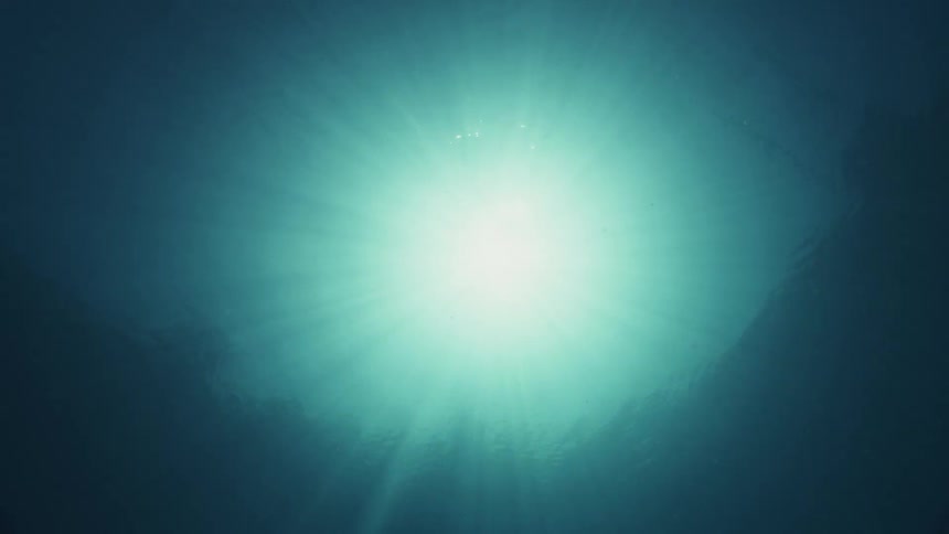 Underwater with the sun and the sky above