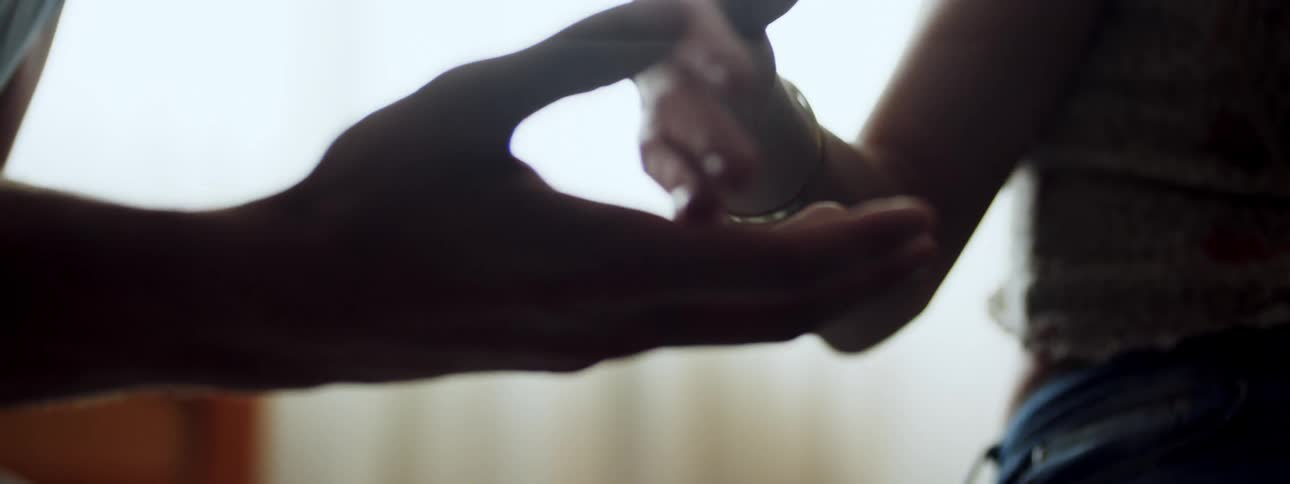A white man and white woman caress each others hands