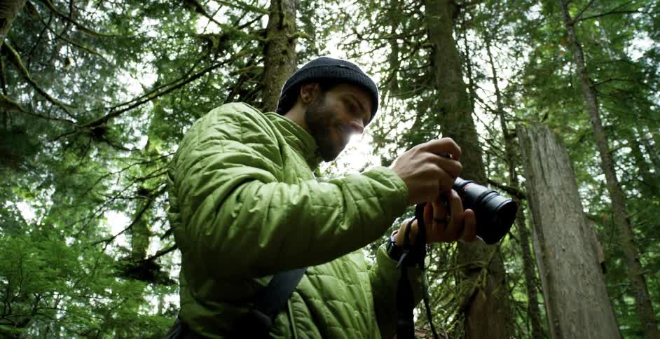 A man takes pictures in a forest