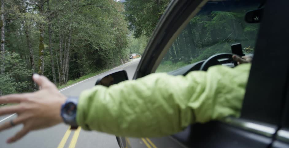 Driving on road through the woods enjoying the fresh air