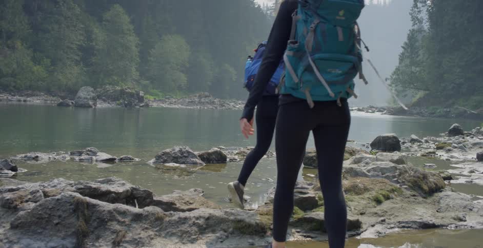 Two women hike around the lake