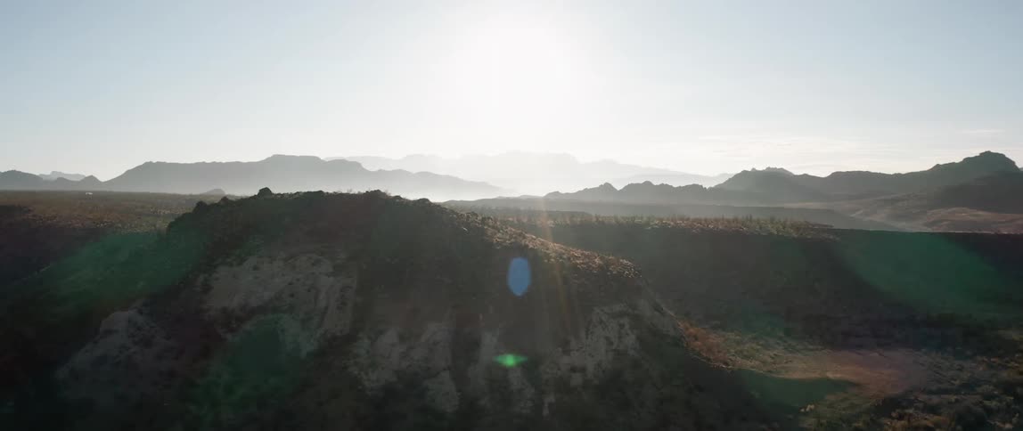 A landscape view of cliffs canyons and a mountain range