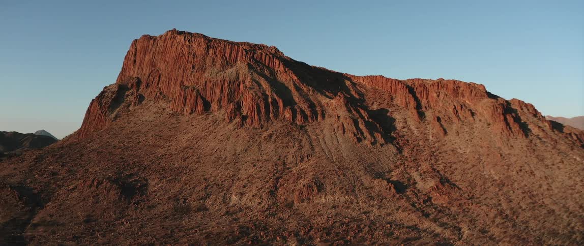 A mountain ringed by an escarpment in the desert