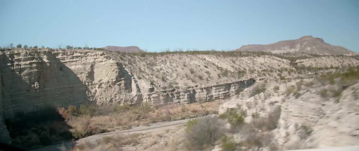 View of a mountain range from inside a car as it drives past