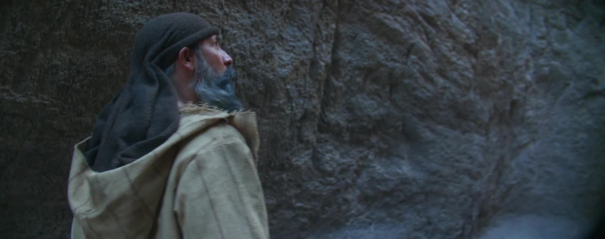 A man hikes in the canyon before stopping