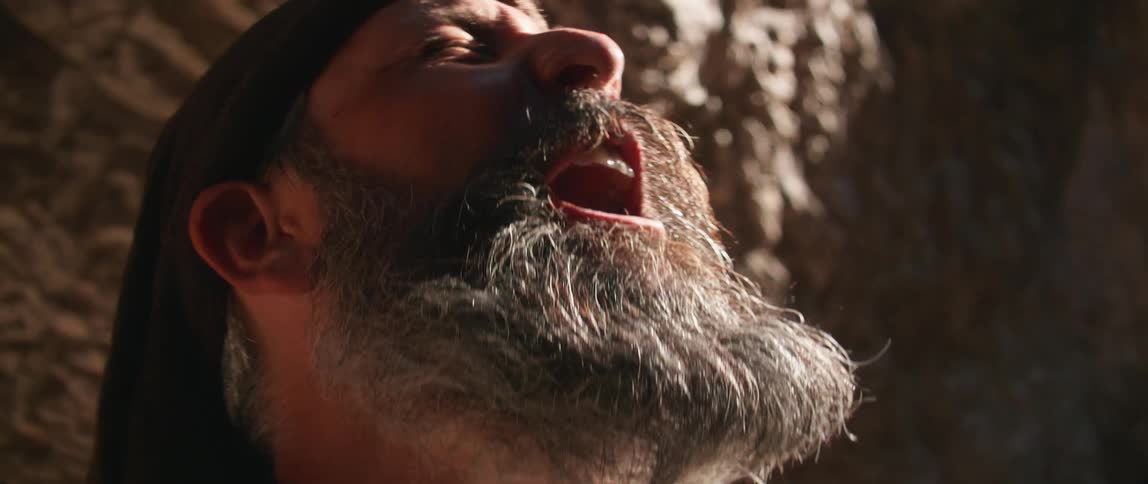 A man looks up towards the sky and yells