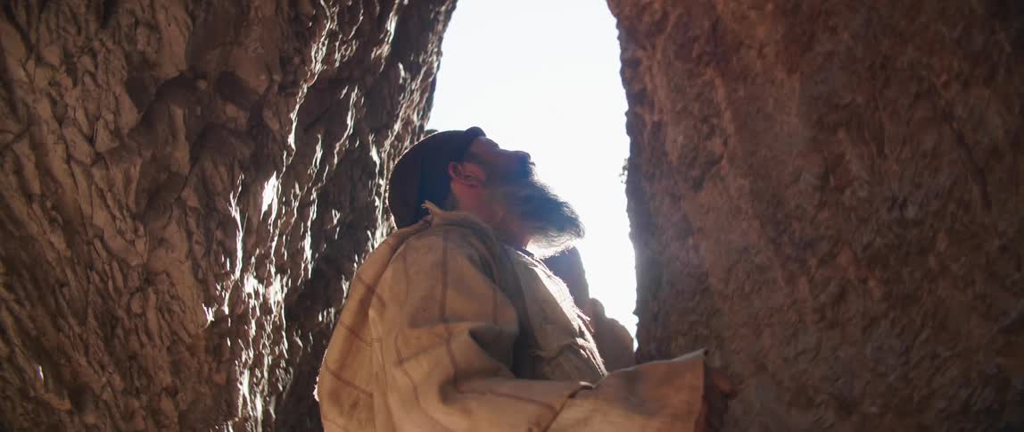 A man is looking at the sky in the cave