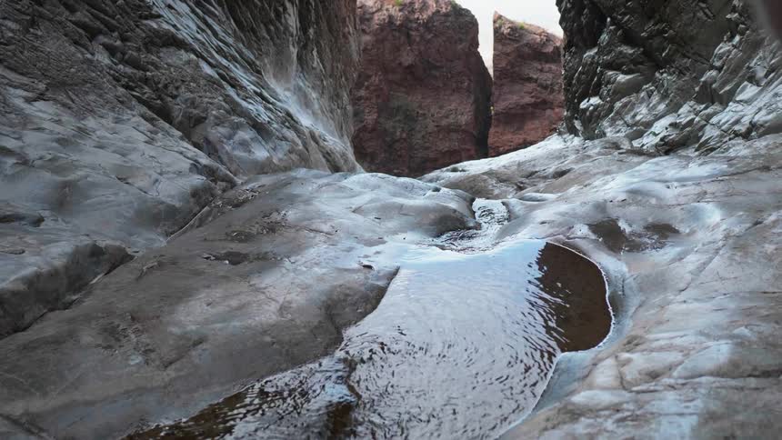Water ripples as it flows over rock in a canyon