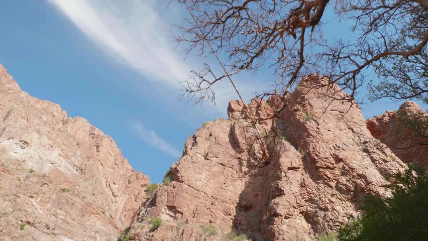 Steep rock cliff on a mountain side at day