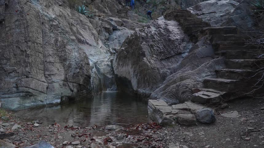 Stairs carved in the rock of a mountain near a small stream of water