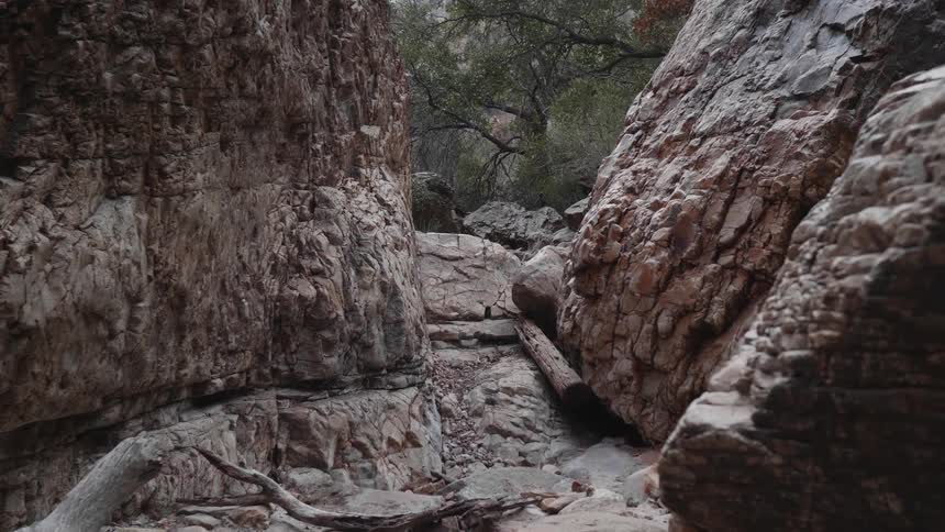 A narrow canyon runs between huge slabs of rock