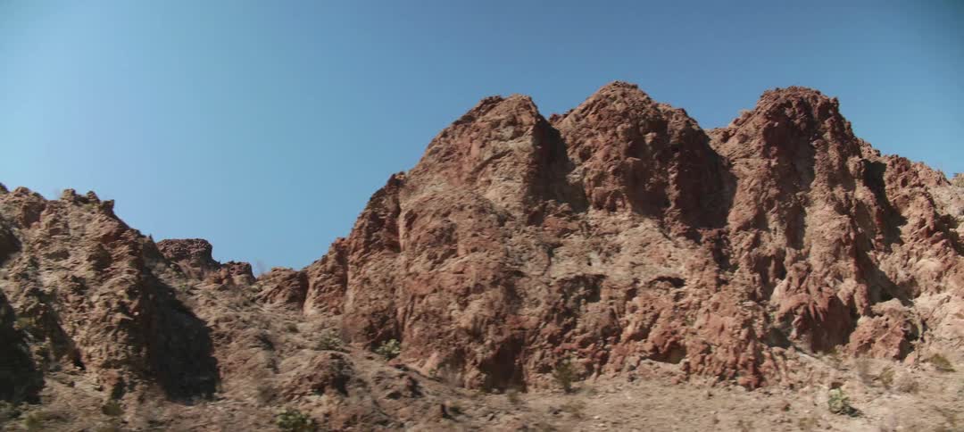 A small mountain range stretches through a desert area