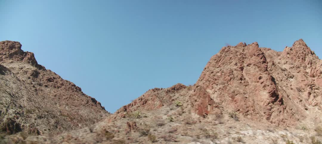 A valley sits between two mountainous areas in a desert
