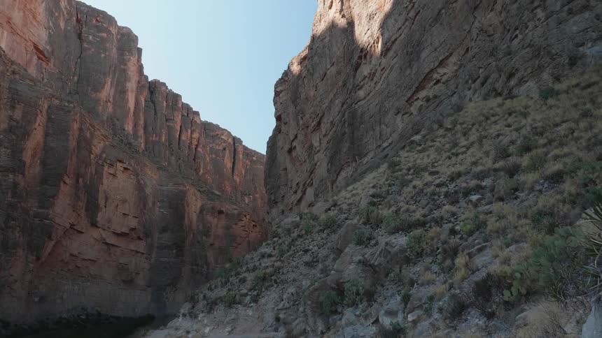 Canyon between steep and tall rocky cliffs in the badlands