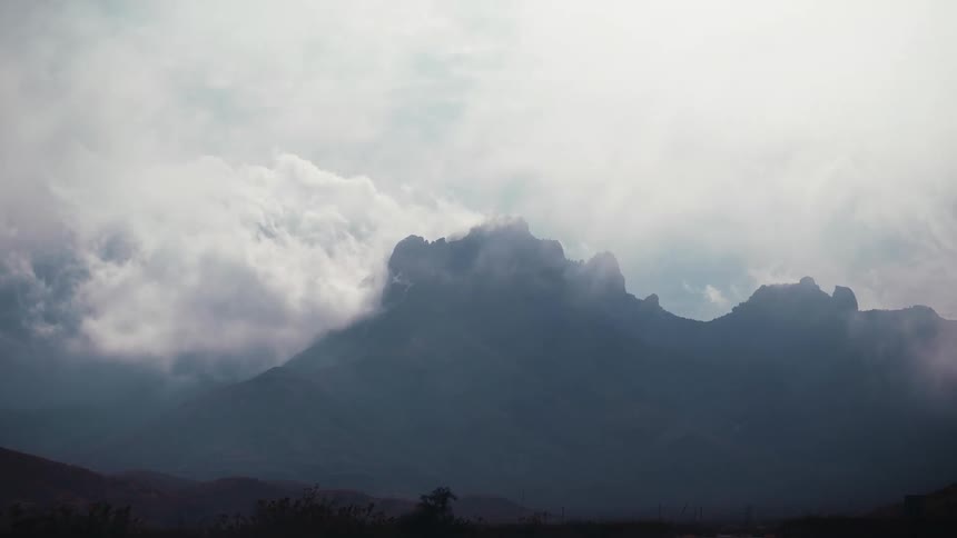 The mountains are covered in heavy clouds