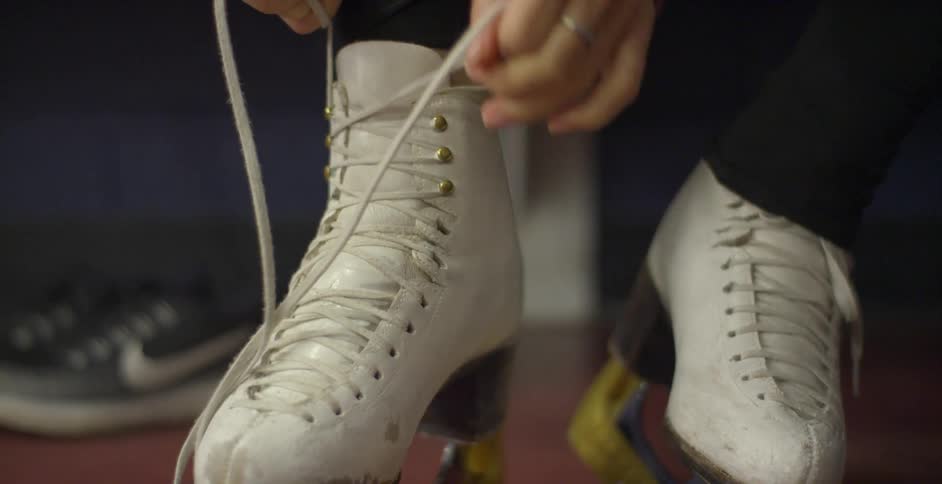 Laces being tied on an old pair of ice skates