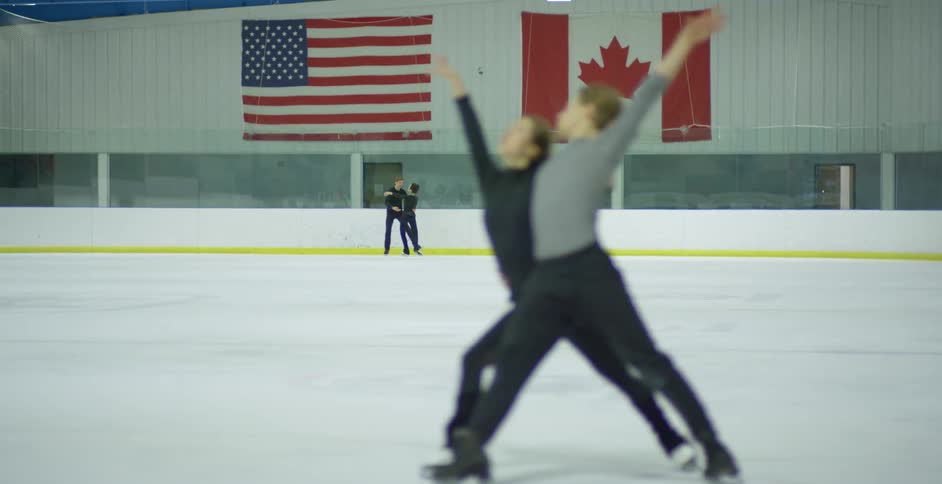A man and a woman figure skating in a skating rink