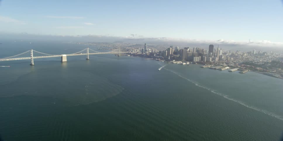 A boat sails away from a coastline of a major city downtown
