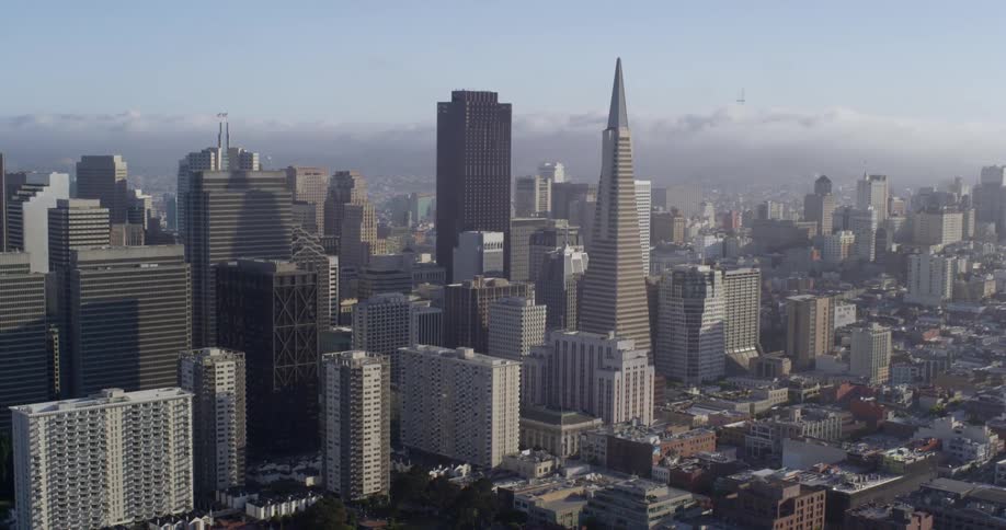 Cloud bank and haze covers horizon behind city downtown