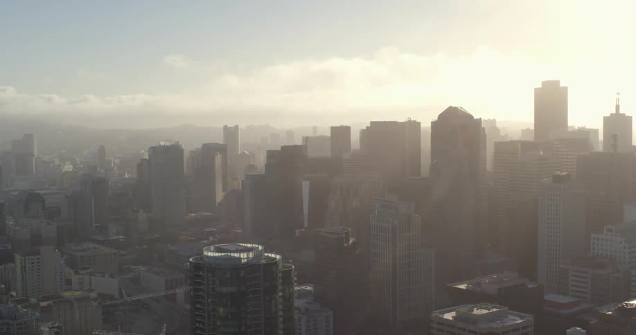 Aerial view of tall buildings as the sun shines bright