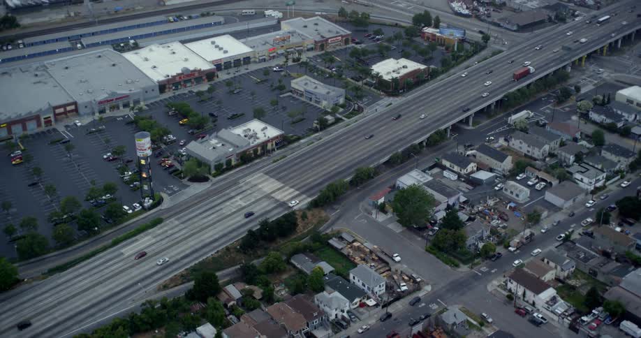 Cars are driving on a highway in a city