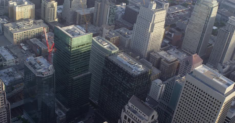 Aerial view of rooftops of buildings with streets in urban area
