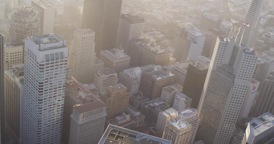 The sun shines bright over city buildings