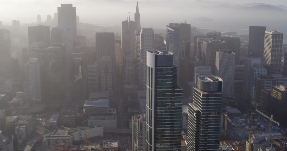 Tall skyscrapers butt against the ocean in a dense city