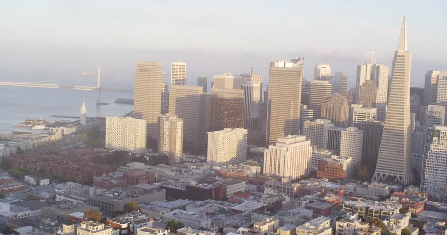 The city is full of tall buildings on a foggy day