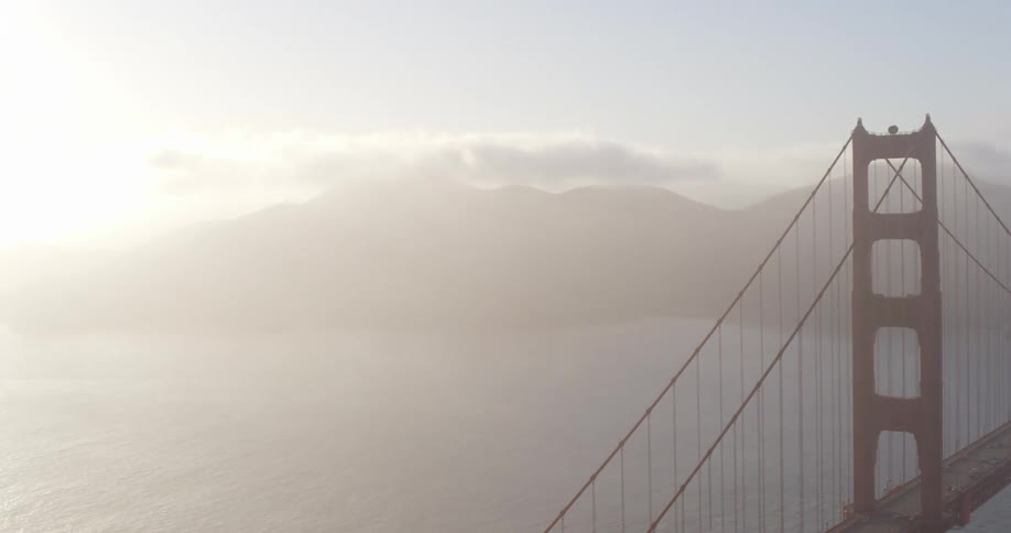 Cars traveling across the golden gate bridge on a hazy day